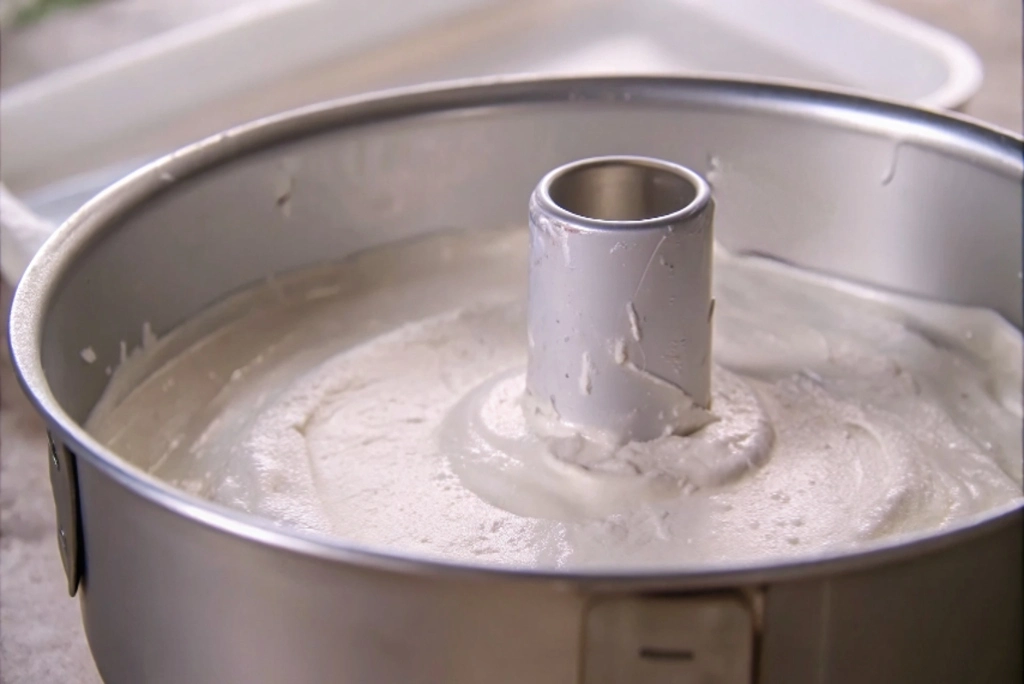 Unbaked angel food cake batter in a tube pan ready for the oven